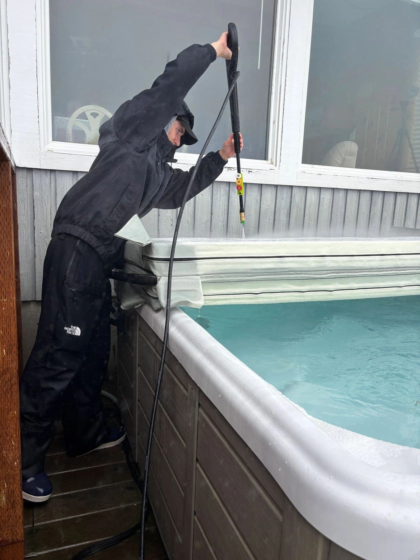 Vacuuming debris from the bottom of a spa
