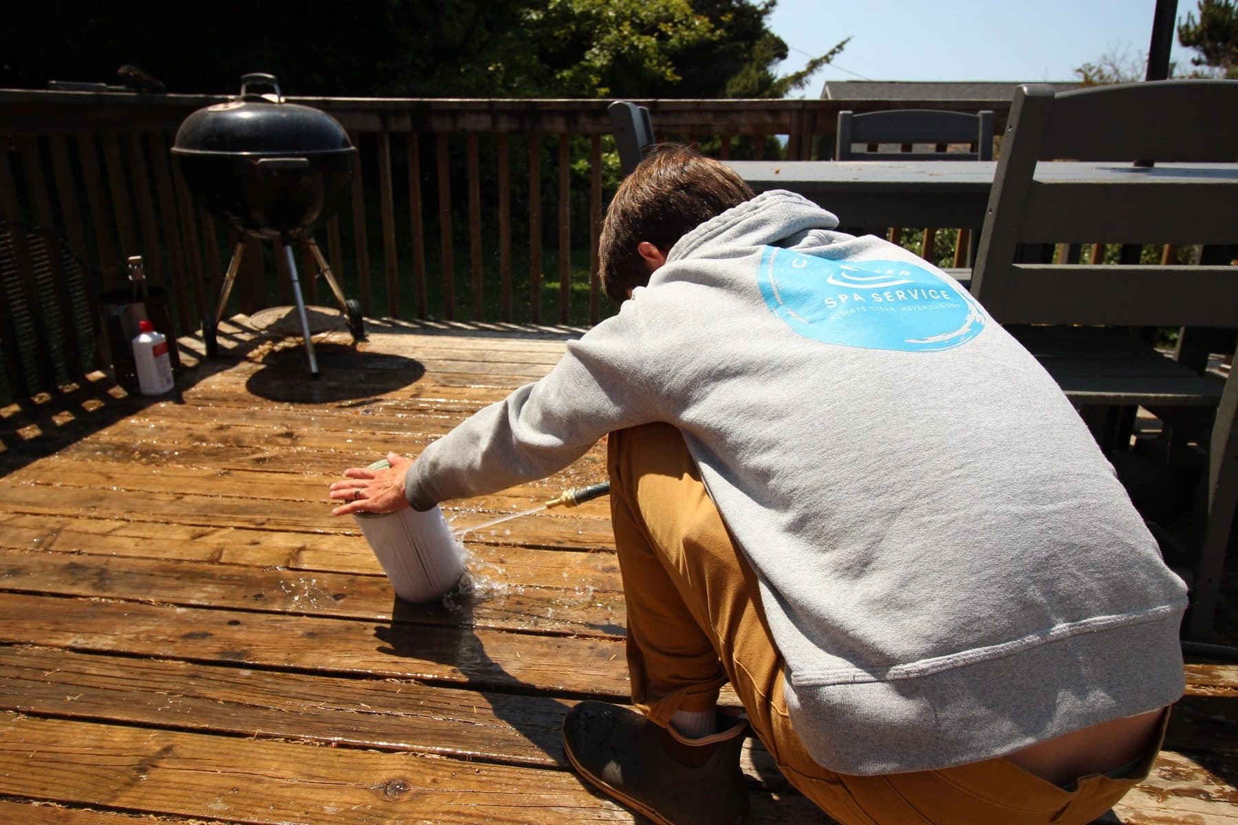 Cleaning up the deck area around a serviced spa