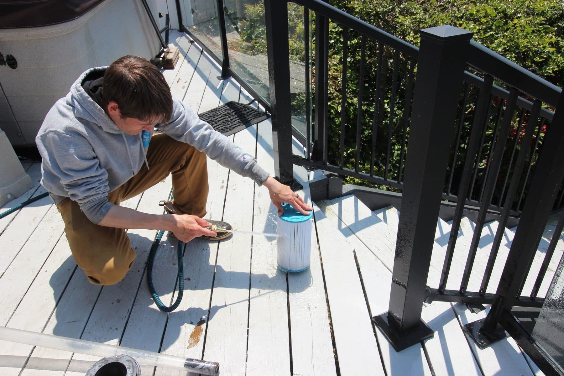 Servicing a hot tub filter on a deck
